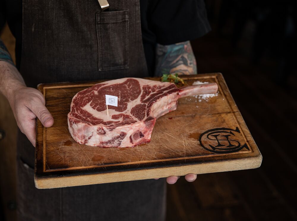 A delicious steak on a wooden cutting board at Chuck's Steakhouse in Banff, Canada.